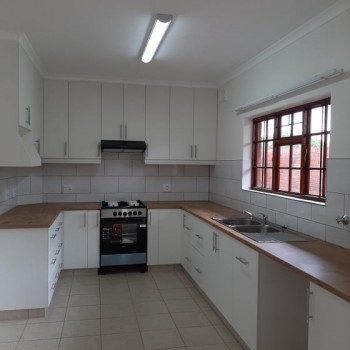 built in white kitchen cupboards with solid wood top