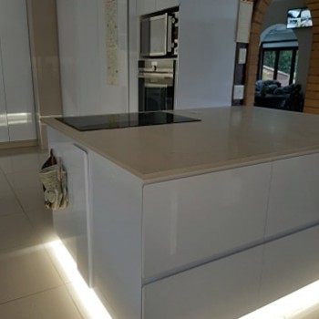 gloss white custom kitchen cabinets with bespoke lighting